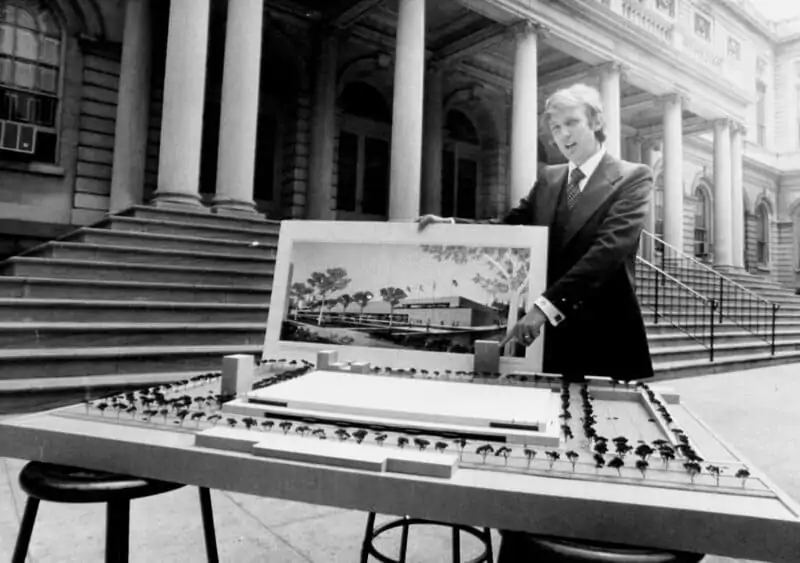 Donald Trump stands behind the architect's model of City Hall Plaza. (Getty Images)