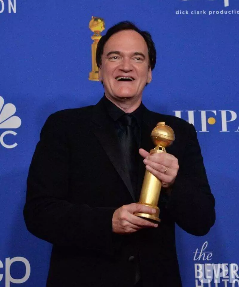 Quentin Tarantino wins an award at the 77th Globe Award.