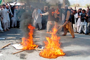 Demonstrators in Jalalabad burning Danish and Dutch flags.